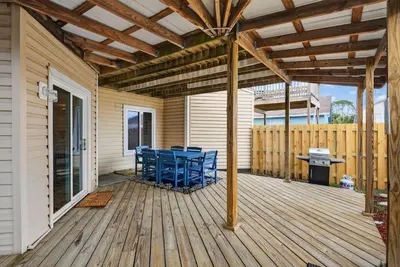a patio with blue chairs on a wooden deck at Emerald Escape 2 - 3 Blocks to Beach in Panama City Beach