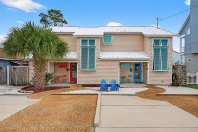 a house with two blue chairs in front of it at Emerald Escape 2 - 3 Blocks to Beach in Panama City Beach