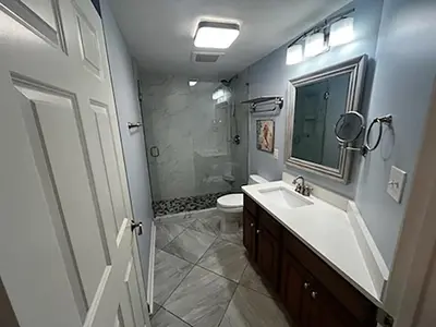 a bathroom with a sink and a toilet and a mirror at Seychelles 701 by Emerald Coast Retreats in Panama City Beach