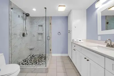 a bathroom with a shower and a toilet and a sink at Seychelles 701 by Emerald Coast Retreats in Panama City Beach
