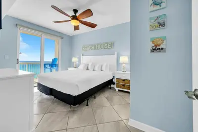 a bedroom with a bed and a ceiling fan at Seychelles 701 by Emerald Coast Retreats in Panama City Beach