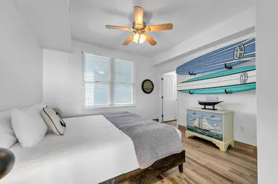 a bedroom with a bed and a ceiling fan at Aqua Resort 2003 in Panama City Beach