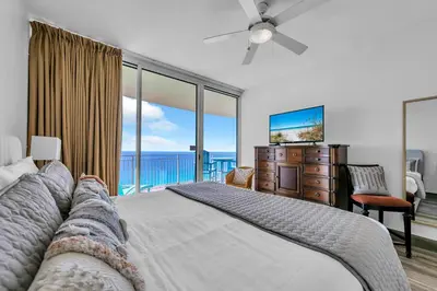a bedroom with a bed with a view of the ocean at Aqua Resort 2003 in Panama City Beach