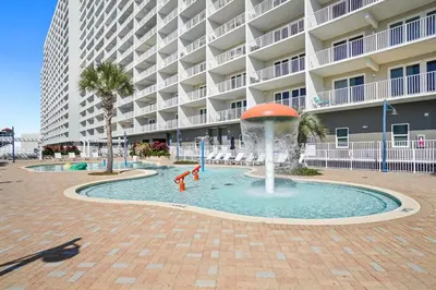 a fountain in front of a large apartment building at Laketown Wharf Beach Resort in Panama City Beach