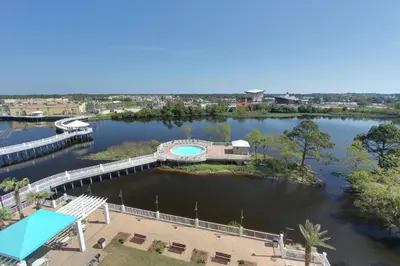 arial view of a river with a bridge and a building at Laketown Wharf Beach Resort in Panama City Beach