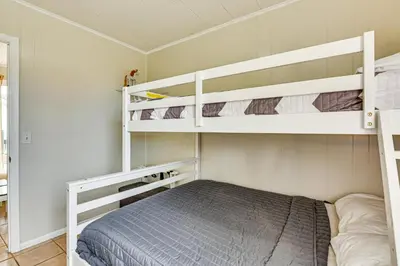 a small bedroom with two bunk beds in it at Two by Sea Beachfront Private Home with Courtyard! in Panama City Beach