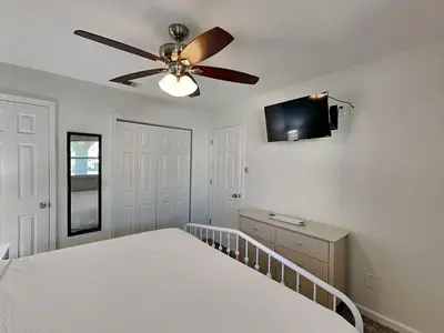 a bedroom with a bed and a ceiling fan at Gulf Highlands #134F in Panama City Beach