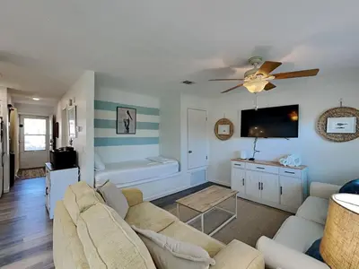 a living room with a couch and a flat screen tv at Gulf Highlands #134F in Panama City Beach