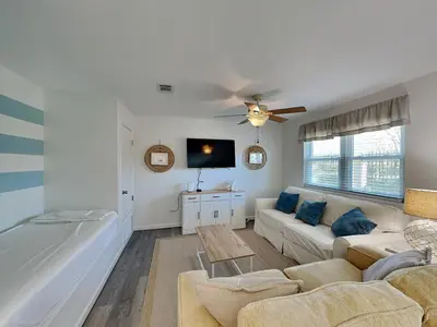 a living room with a couch and a tv at Gulf Highlands #134F in Panama City Beach