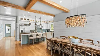a dining room and kitchen with a table and chairs at Southern Sol in Watersound Beach
