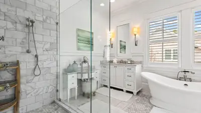 a white bathroom with a tub and a shower at Southern Sol in Watersound Beach