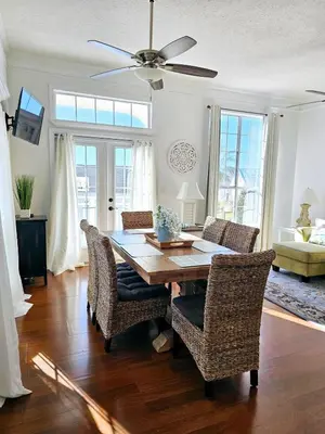a dining room with a table and chairs at You, Me & the Sea! in Panama City Beach