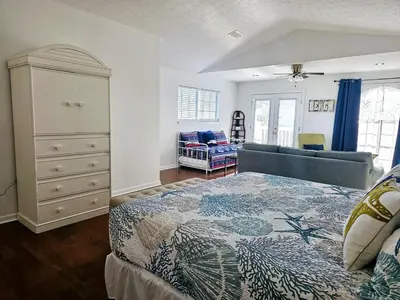 a bedroom with a bed and a dresser in it at You, Me & the Sea! in Panama City Beach