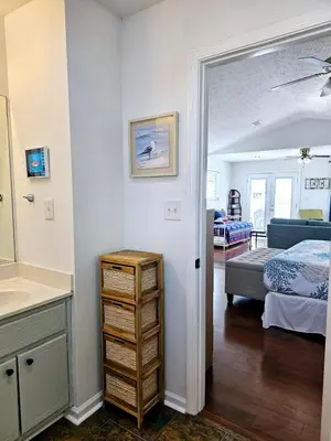 a bedroom with a bed and a dresser in a room at You, Me & the Sea! in Panama City Beach