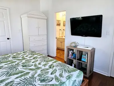 a bedroom with a bed and a flat screen tv at You, Me & the Sea! in Panama City Beach