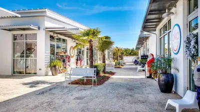 a street with a bench in front of a store at Prominence 14B in Rosemary Beach