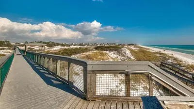 a boardwalk leading to the beach and the ocean at Prominence 14B in Rosemary Beach
