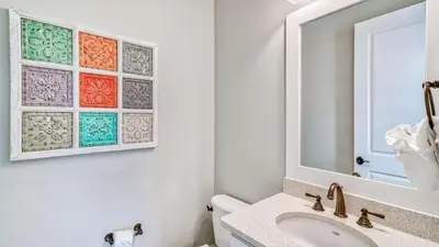 a bathroom with a sink and a mirror at NatureWalk at Seagrove 985 in Santa Rosa Beach