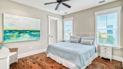 a bedroom with a bed and a painting on the wall at NatureWalk at Seagrove 985 in Santa Rosa Beach