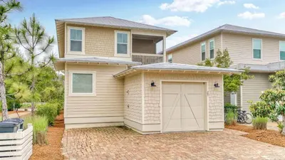 a house with a garage in front of it at NatureWalk at Seagrove 985 in Santa Rosa Beach