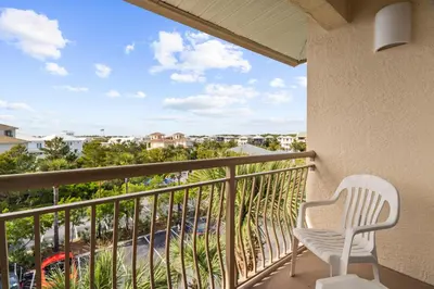 a balcony with a chair and a view of a street at High Pointe 431 Gulf Views in Rosemary Beach
