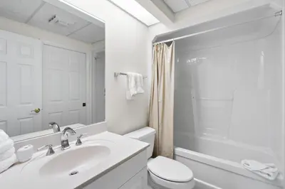 a white bathroom with a sink and a toilet at High Pointe 431 Gulf Views in Rosemary Beach