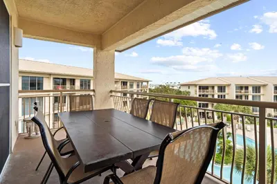 a patio with a table and chairs on a balcony at High Pointe 431 Gulf Views in Rosemary Beach