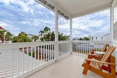 a balcony with chairs and a view of the ocean at Spacious Home with Private Pool dog-friendly 2 Blocks to Beach in Santa Rosa Beach