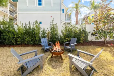 three chairs and a fire pit in a yard at Beach,Please in Rosemary Beach