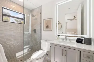 a bathroom with a toilet and a sink and a shower at Beach,Please in Rosemary Beach