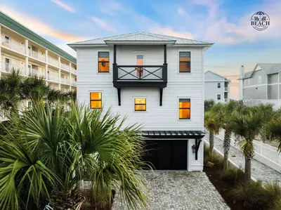 a white house with orange doors and palm trees at Beach,Please in Rosemary Beach