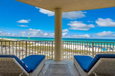 a balcony with chairs and a view of the beach at Stunning beachfront condo with shared pool & beach access in Santa Rosa Beach