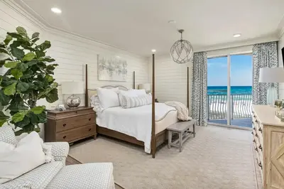 a bedroom with a bed and a view of the ocean at Stunning beachfront condo with shared pool & beach access in Santa Rosa Beach