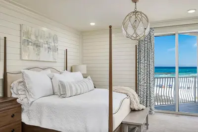a bedroom with a bed and a view of the ocean at Stunning beachfront condo with shared pool & beach access in Santa Rosa Beach