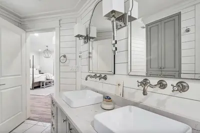 a white bathroom with two sinks and a mirror at Stunning beachfront condo with shared pool & beach access in Santa Rosa Beach