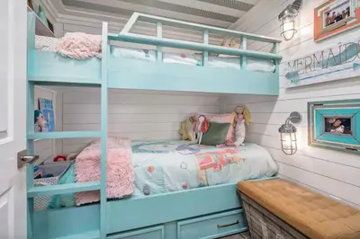 a bedroom with bunk beds in a house at Stunning beachfront condo with shared pool & beach access in Santa Rosa Beach
