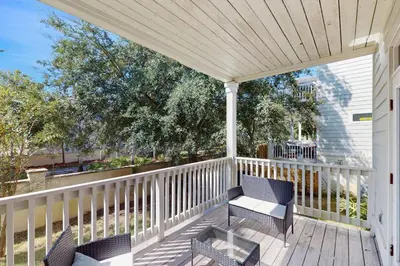 a porch with two chairs and a table at New Cottage Near 30A Rosemary Beach with 2 Master Suites in Inlet Beach