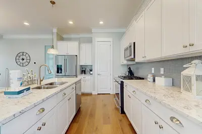 a kitchen with white cabinets and marble counter tops at New Cottage Near 30A Rosemary Beach with 2 Master Suites in Inlet Beach
