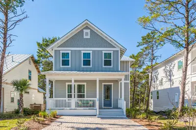 a home with a blue and white house at Lovely Two-Story Home with Porches Access to Pool & Dock in Inlet Beach