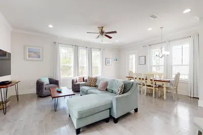 a living room with a couch and a table at Lovely Two-Story Home with Porches Access to Pool & Dock in Inlet Beach