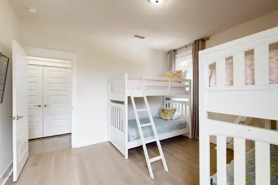 a room with two bunk beds and a ladder at Lovely Two-Story Home with Porches Access to Pool & Dock in Inlet Beach
