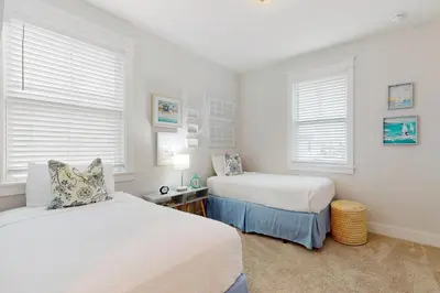 a bedroom with two beds and two windows at Brand-new house on Powell Lake near beach & 30A with pool W&D & gym in Inlet Beach