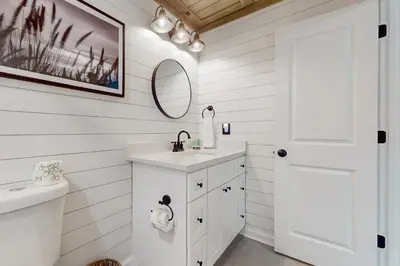 a white bathroom with a sink and a mirror at Beautiful coastal studio condo with pool in Santa Rosa Beach