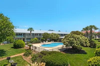an exterior view of a resort with a swimming pool at Beautiful coastal studio condo with pool in Santa Rosa Beach