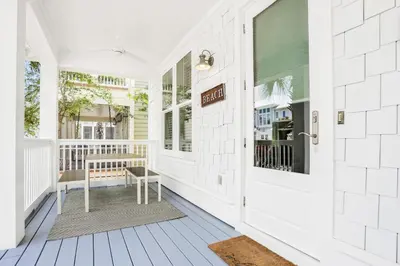 a porch with a bench and a window at Relaxing getaway outdoor pool access gym bikes central AC & W&D in Inlet Beach