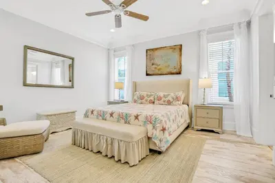 a bedroom with a bed and a ceiling fan at Relaxing getaway outdoor pool access gym bikes central AC & W&D in Inlet Beach