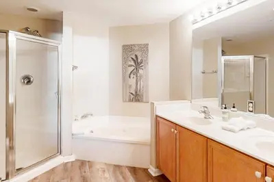 a bathroom with a tub and a sink and a shower at Condo with 2 stunning pools hot tub gym partial Gulf view & pickleball in Santa Rosa Beach