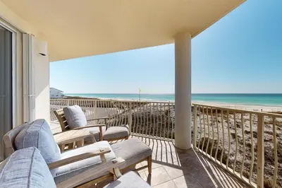 a balcony with chairs and a view of the beach at Gulf-front 3-bedroom condo with bonus bunk room & pickleball in Santa Rosa Beach