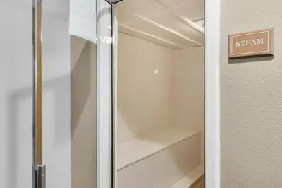 a walk in closet with a clear glass door at Gulf-front 3-bedroom condo with balconies off each bedroom & pickleball in Santa Rosa Beach
