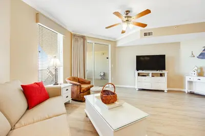 a living room with a couch and a tv at Charming suite with spacious balcony pools tennis & pickleball in Santa Rosa Beach